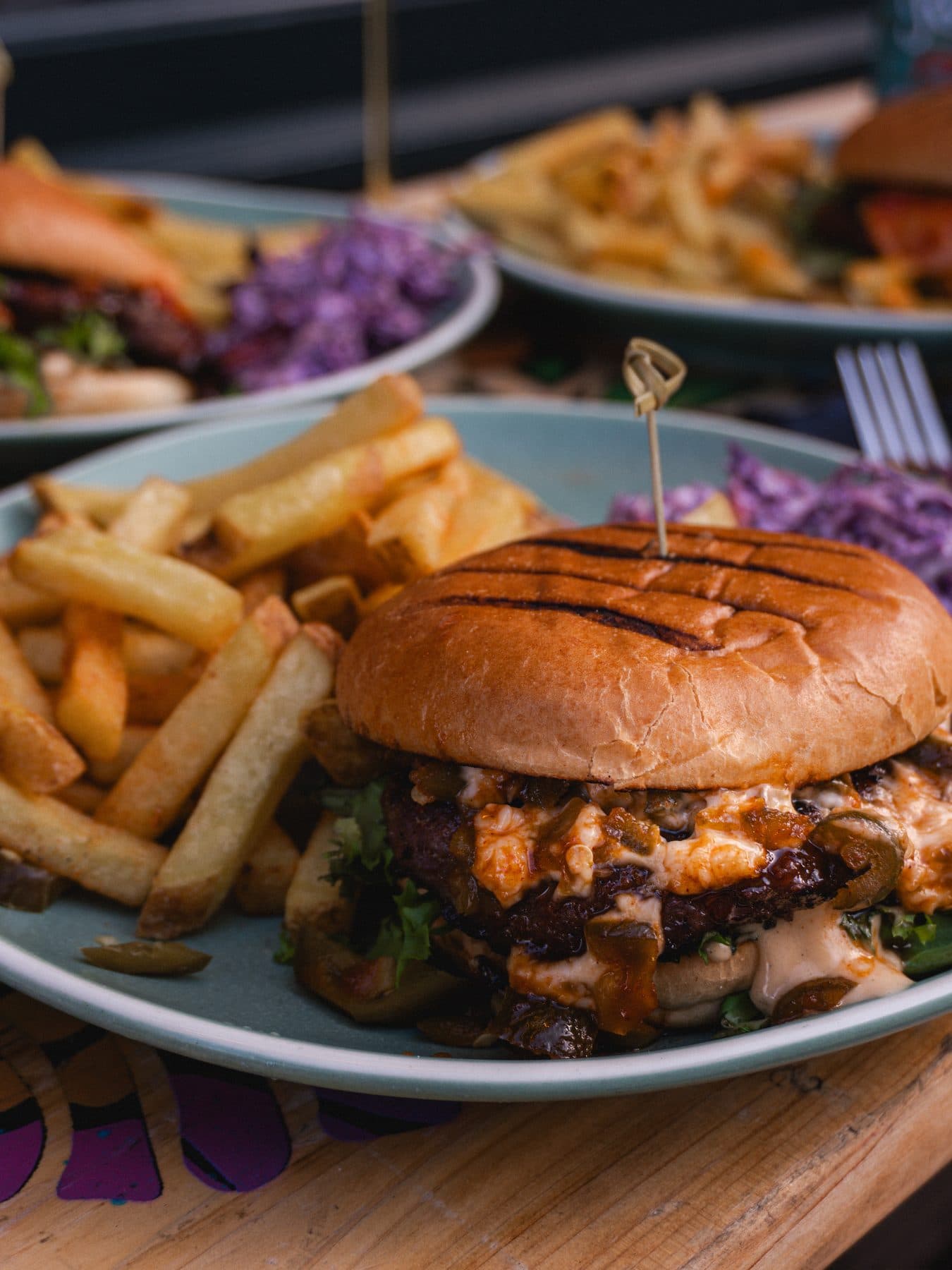 Burger with fries and house slaw at The Tilted Wig